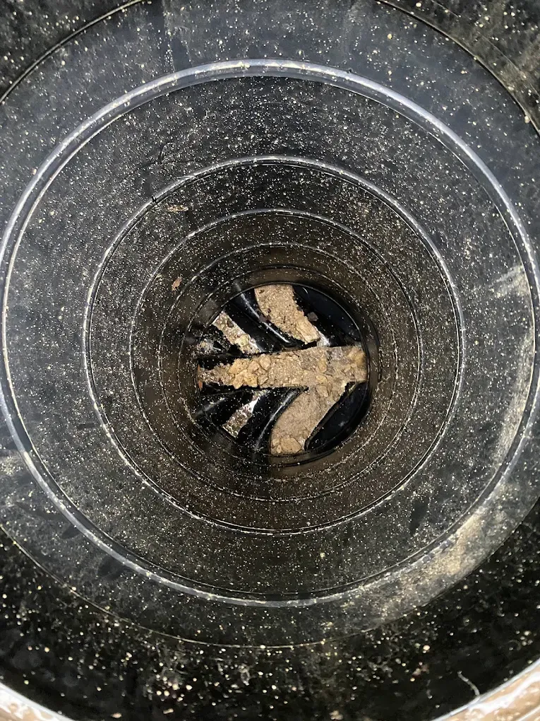 Blocked drain with debris visible inside.