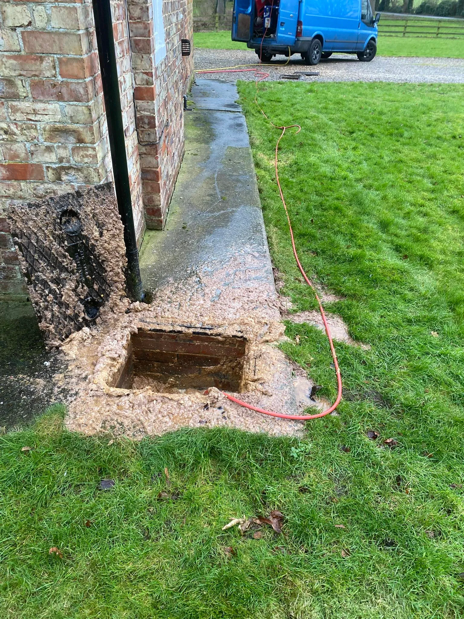 Picture of a heavily blocked external drain overflowing